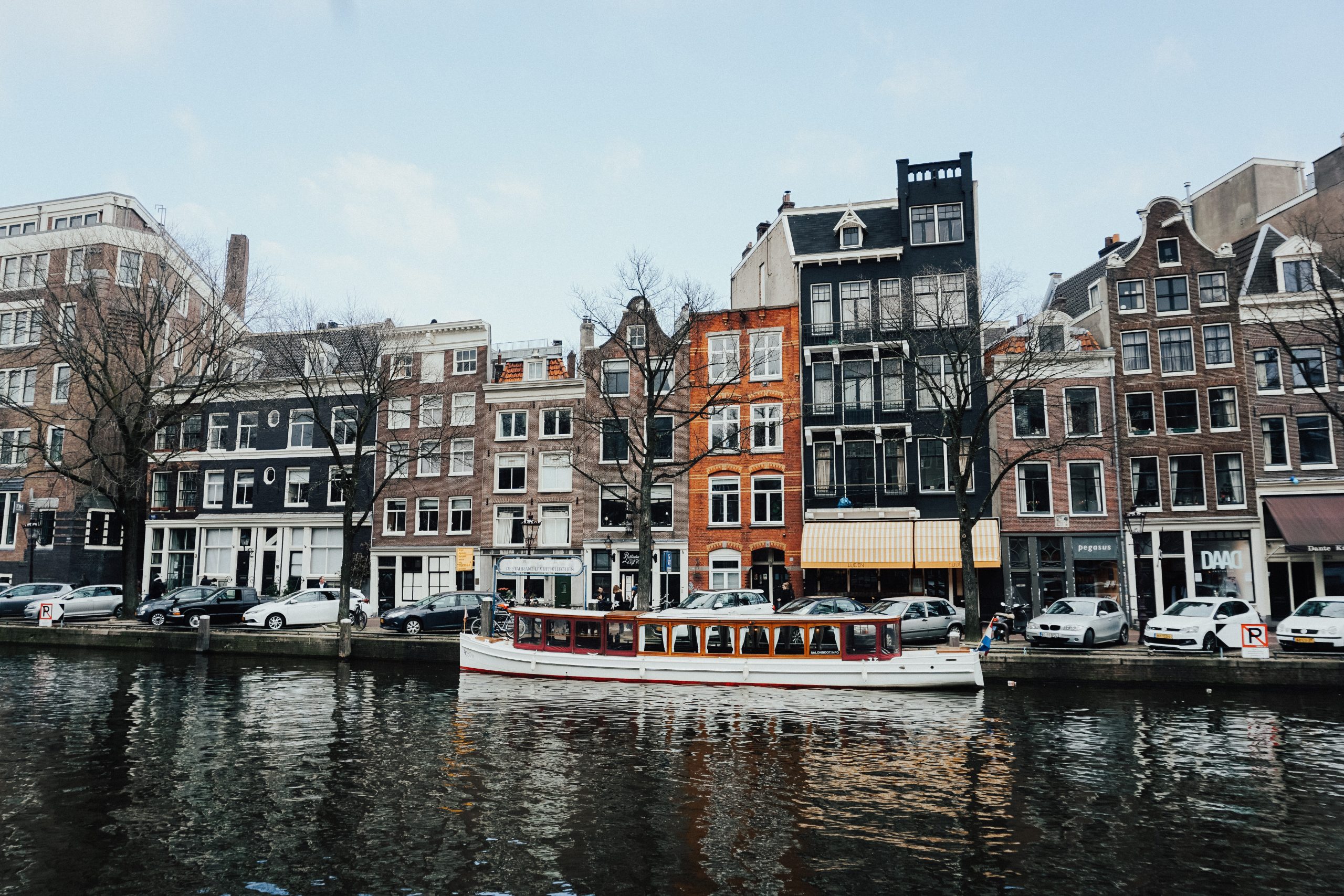 A coworking space in Amsterdam with a boat on a canal.